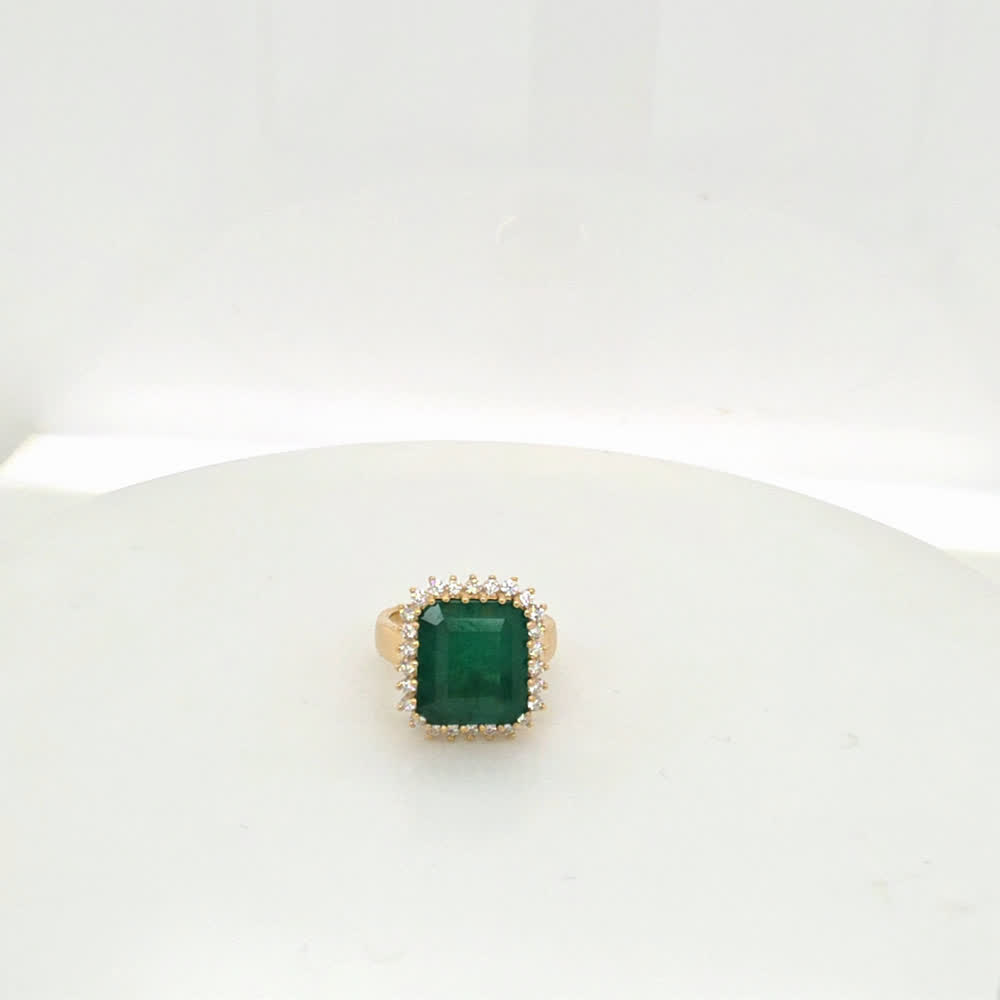7 carat Brazilian emerald ring in 14kt yellow gold with a halo of natural F-G VS1 diamonds